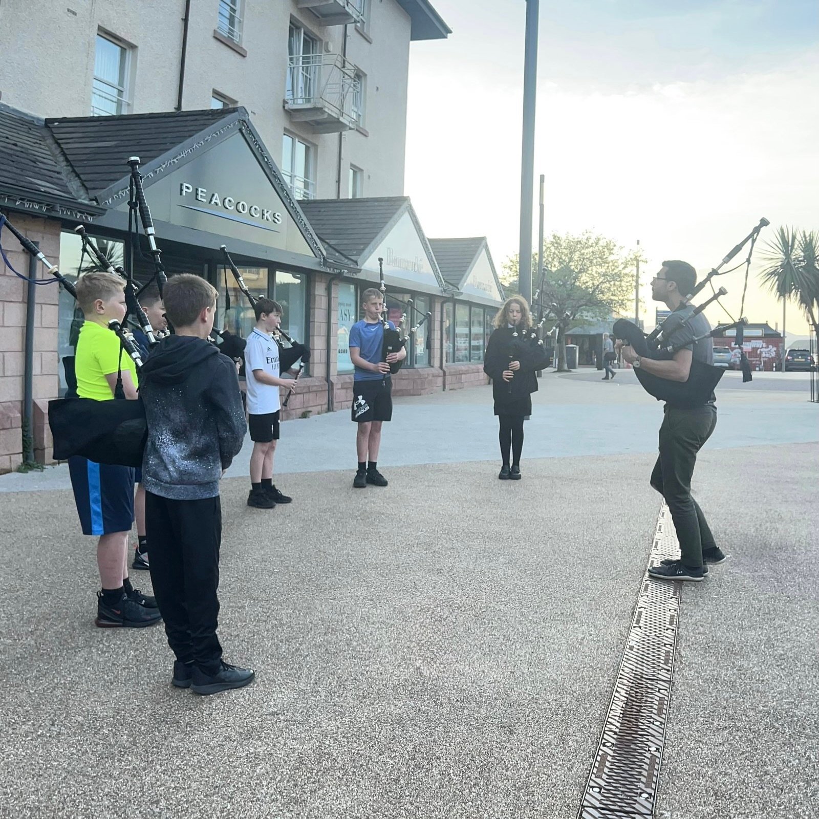 A group of pipers practising outdoors