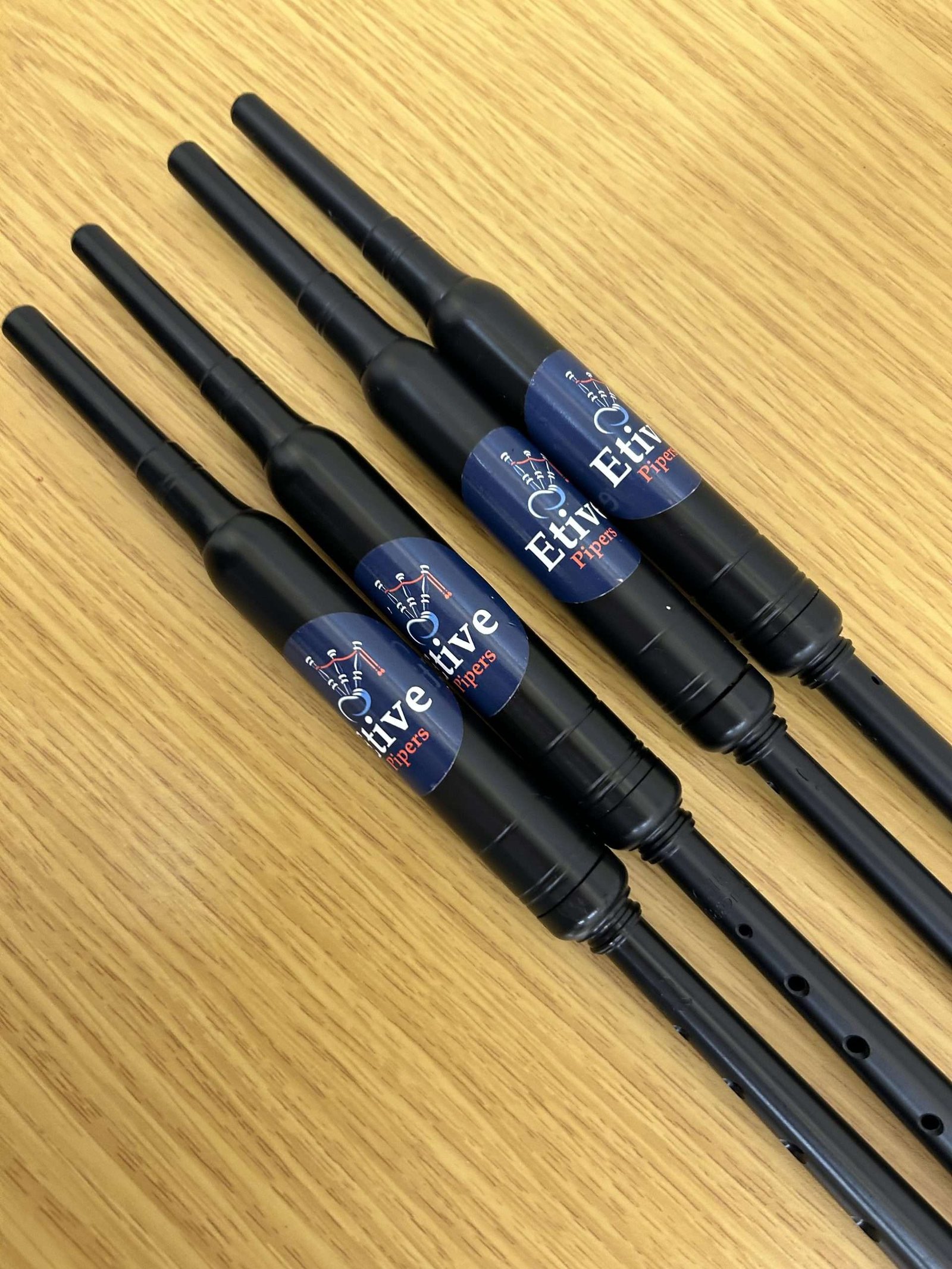 A row of Etive Pipers practice chanters
