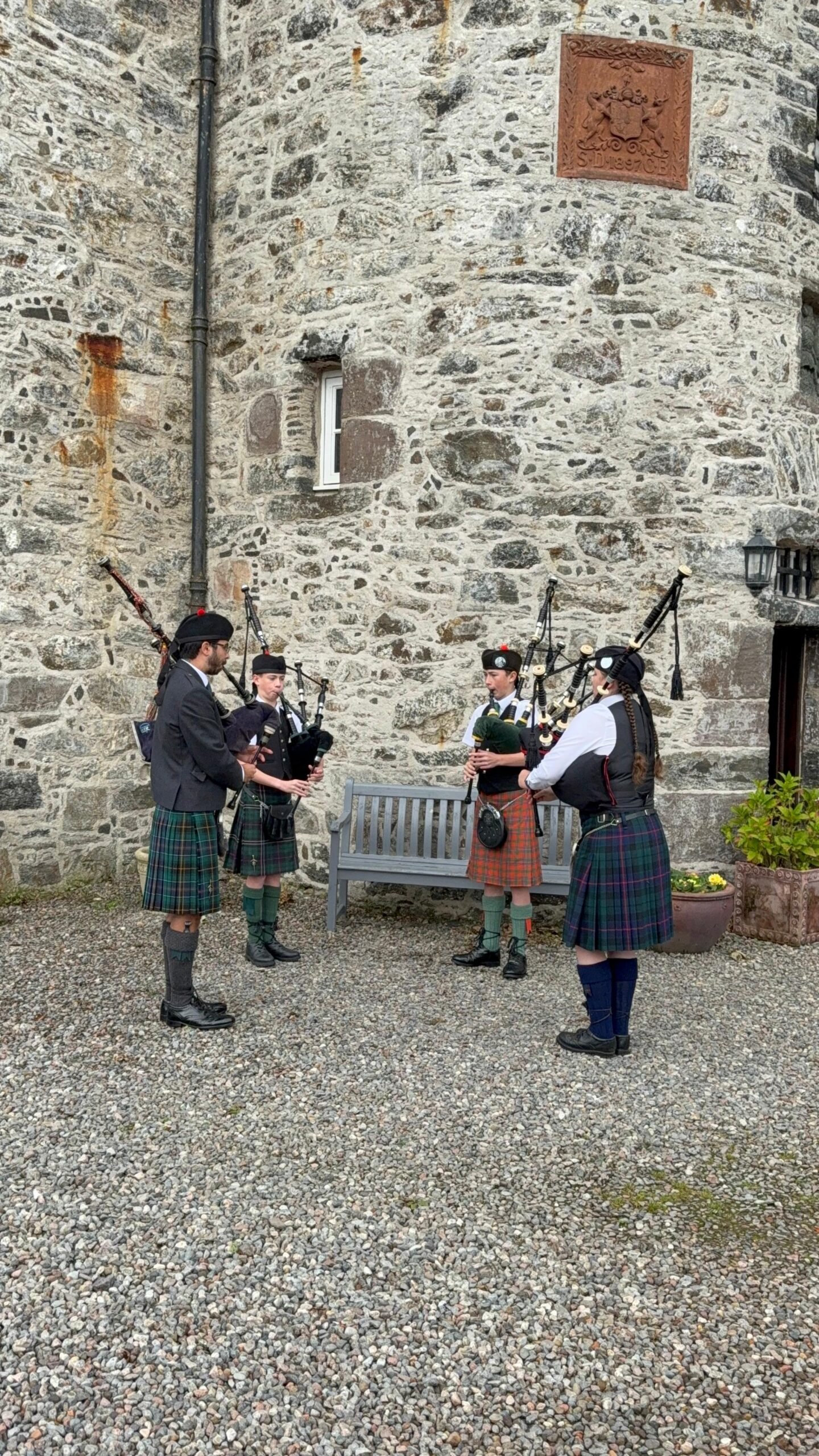 Quartet of older pipers performing at wedding